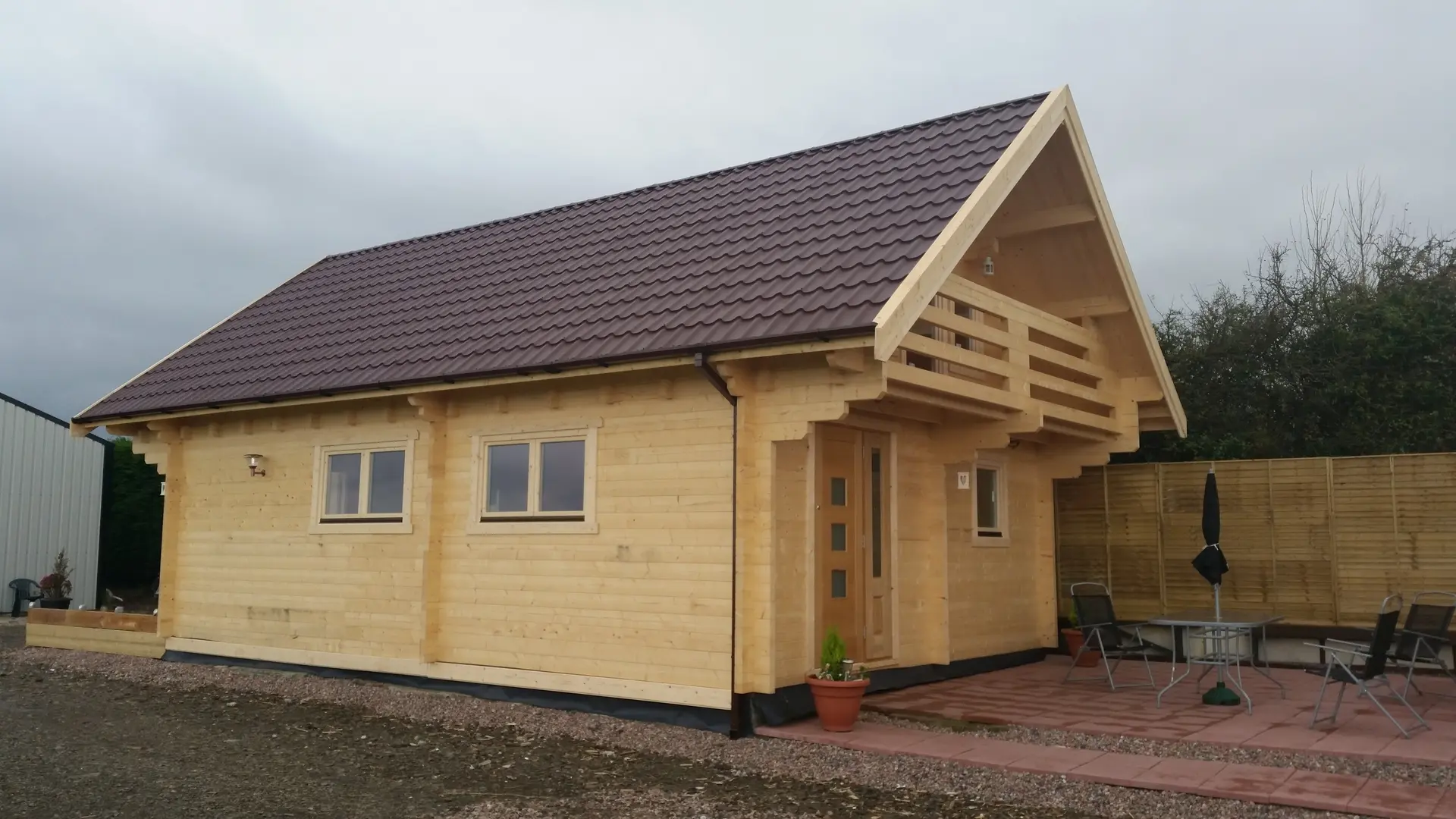 Solid timber cabin under a dramatic autumn sky